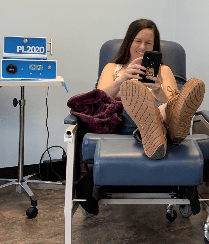 Woman sitting on a chair while using the PL2020 machine