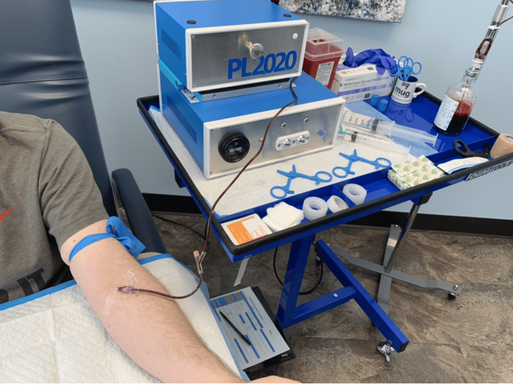 PL2020 Machine in a blue table with a few medical supplies